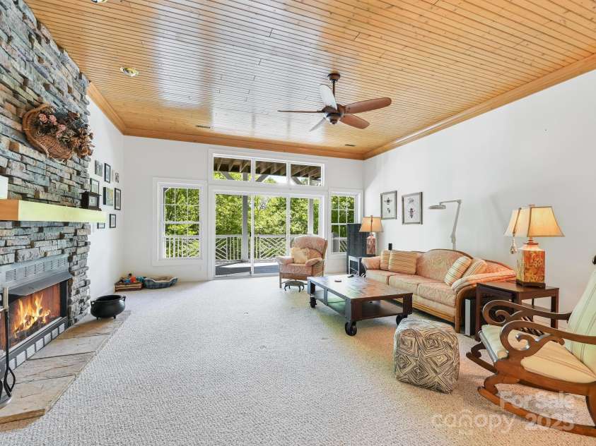 105 Spring Path, Hendersonville, NC 28739.  MLS# CAR4256171, YatesRealty ID 17277. Lower Level family room with doorwall and gas fireplace