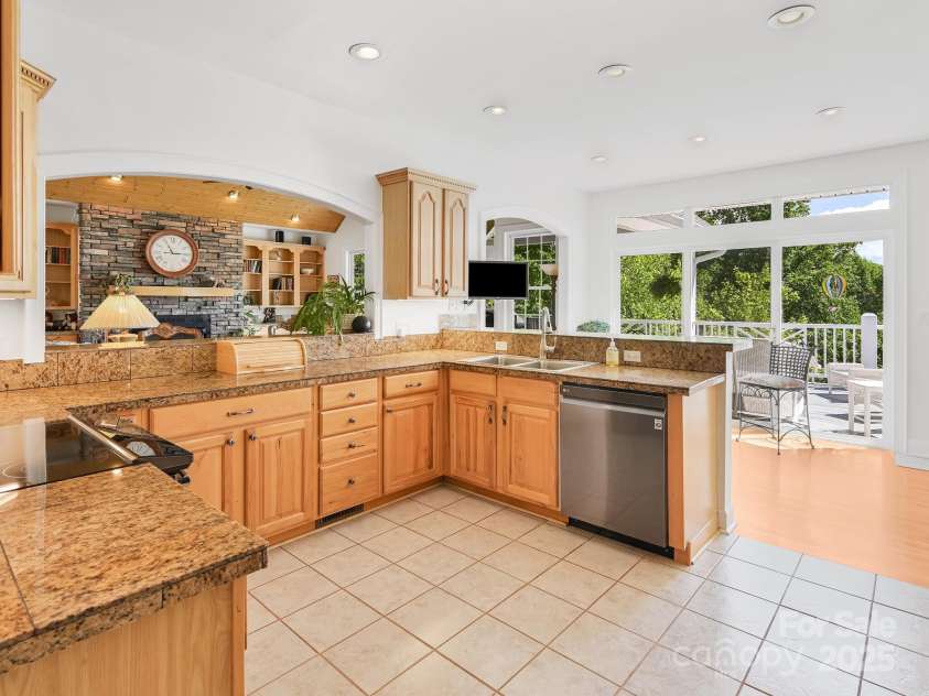 105 Spring Path, Hendersonville, NC 28739.  MLS# CAR4256171, YatesRealty ID 17277. Open kitchen and doorwall to deck