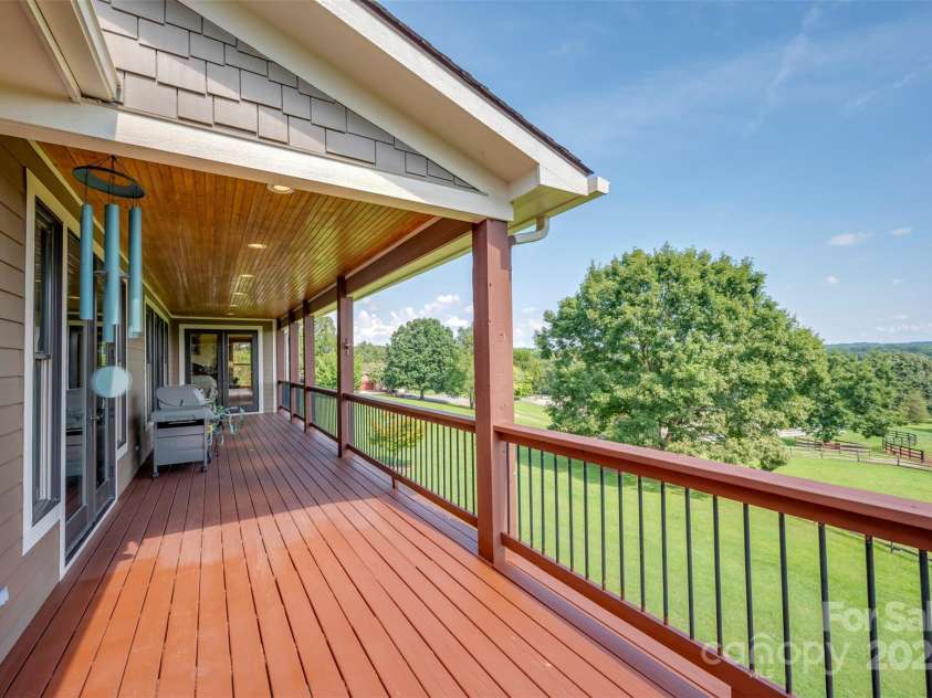 102 Uncle Coss Pond Road, Columbus, NC 28722.  MLS# CAR4267443, YatesRealty ID 17300. Large covered deck overlooking the horse pastures. One open area for your grill and barbecue. 