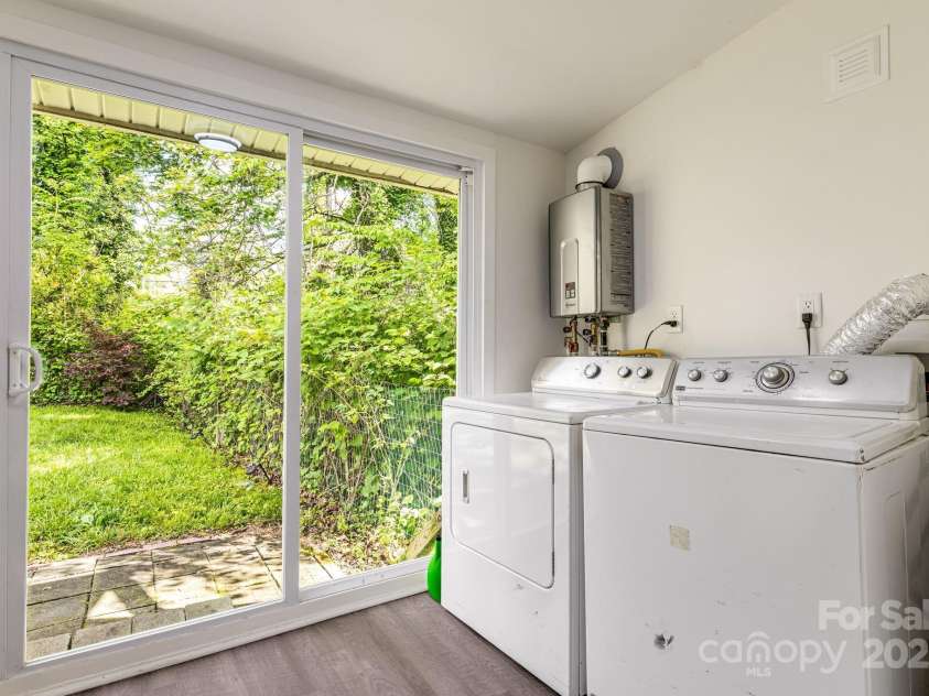 725 1st Avenue, Hendersonville, NC 28739.  MLS# CAR4260106, YatesRealty ID 17308. Laundry with tankless water heater