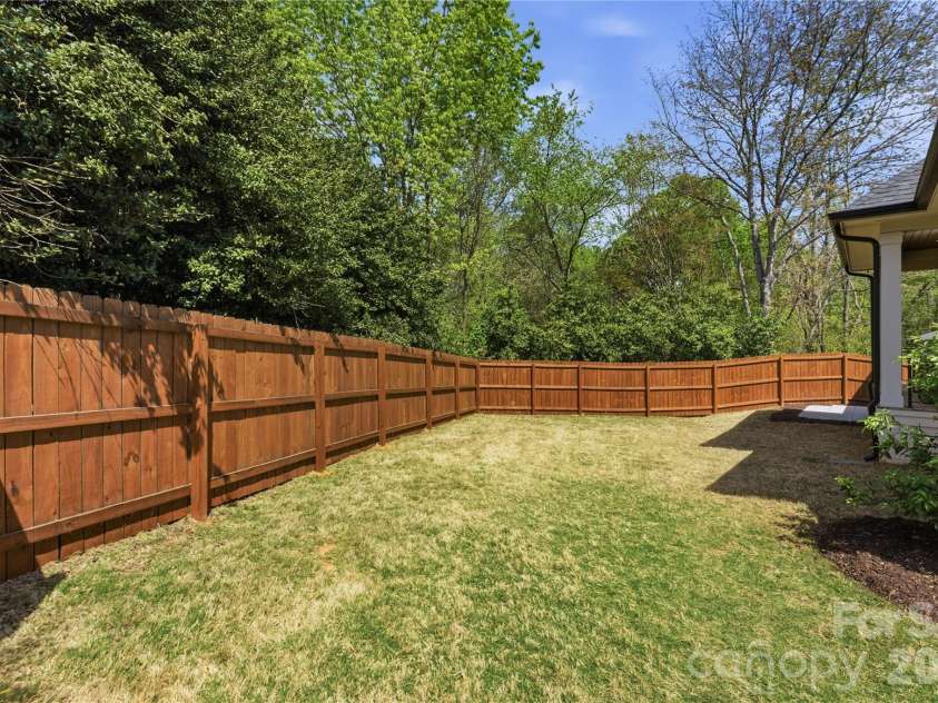 7005 Chateau Bordeaux Lane, Charlotte, NC 28270.  MLS# CAR4361151, YatesRealty ID 17330. Expansive, level backyard space offering flexibility for play, entertaining, or creating your own outdoor retreat.
