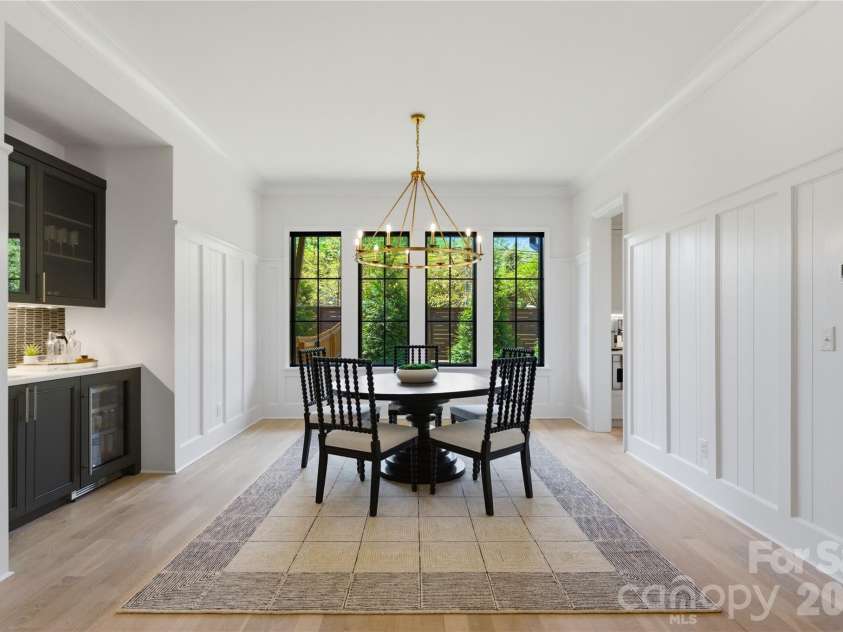 7005 Chateau Bordeaux Lane, Charlotte, NC 28270.  MLS# CAR4361151, YatesRealty ID 17330. Light filled dining space framed by oversized windows and designer lighting, perfect for both intimate dinners and entertaining.