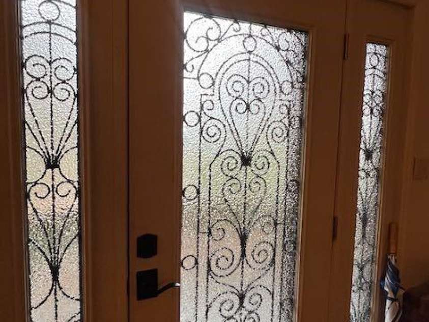 1955 Connestee Trail, Brevard, NC 28712.  MLS# CAR4313257, YatesRealty ID 17335. Custom front door with metal work in between glass panels