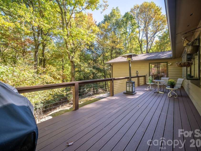 1955 Connestee Trail, Brevard, NC 28712.  MLS# CAR4313257, YatesRealty ID 17335. Expansive back deck off of kitchen