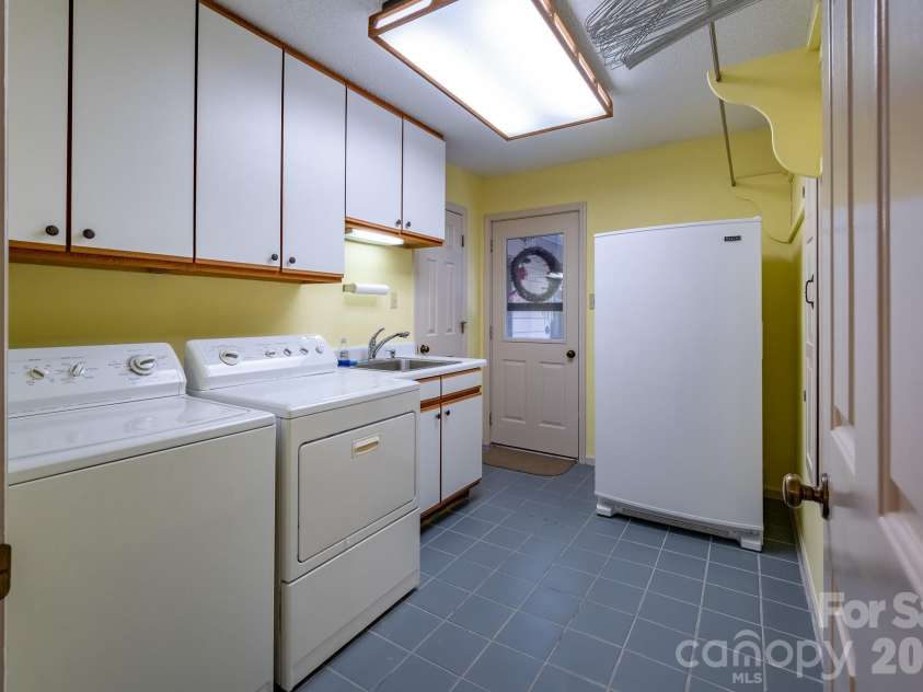 1955 Connestee Trail, Brevard, NC 28712.  MLS# CAR4313257, YatesRealty ID 17335. Laundry room just off of the kitchen