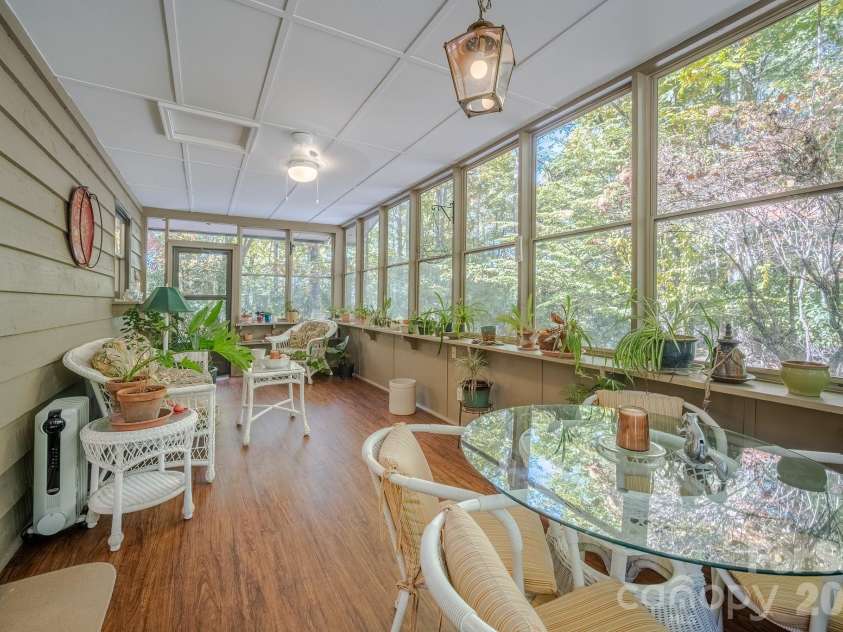 1955 Connestee Trail, Brevard, NC 28712.  MLS# CAR4313257, YatesRealty ID 17335. Relaxing sunroom for your enjoyment