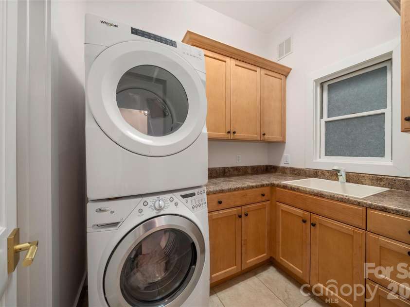 4 Chimney Crest Drive, Asheville, NC 28806.  MLS# CAR4421093, YatesRealty ID 17341. Huge laundry room with sink and so much folding and storage space
