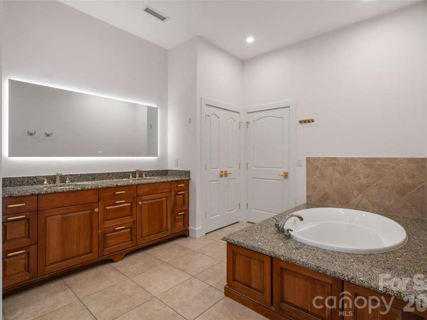 4 Chimney Crest Drive, Asheville, NC 28806.  MLS# CAR4421093, YatesRealty ID 17341. Primary with huge smart mirror