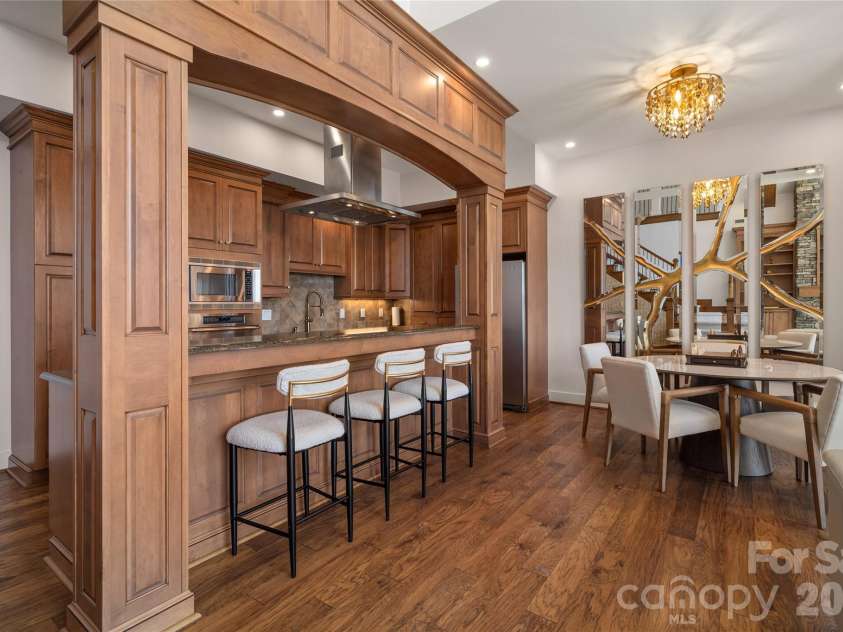 4 Chimney Crest Drive, Asheville, NC 28806.  MLS# CAR4421093, YatesRealty ID 17341. So much storage in this spacious kitchen with custom stainless exhaust hood