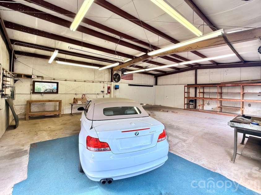 24 Green Acres Drive, Candler, NC 28715.  MLS# CAR4318408, YatesRealty ID 17347. Large Workshop With Workbench And Dedicated Work Area