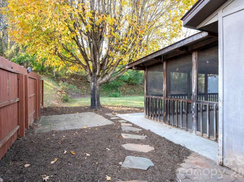 24 Green Acres Drive, Candler, NC 28715.  MLS# CAR4318408, YatesRealty ID 17347. Stone Stepping Path Leading Toward The Backyard