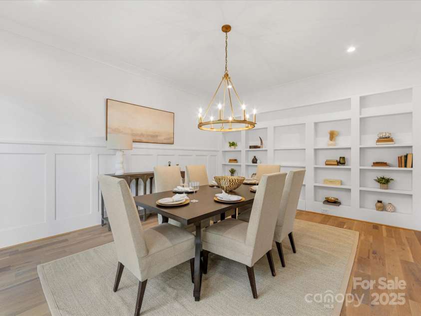 438 Wonderwood Drive, Charlotte, NC 28211.  MLS# CAR4290374, YatesRealty ID 17355. Dining Room with Built-in Bookshelves and hidden door to Scullery