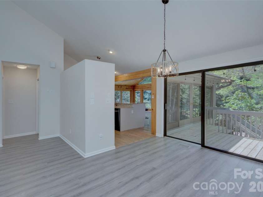 960 Middle Connestee Trail, Brevard, NC 28712.  MLS# CAR4373421, YatesRealty ID 17355. Kitchen and dining room view from living room