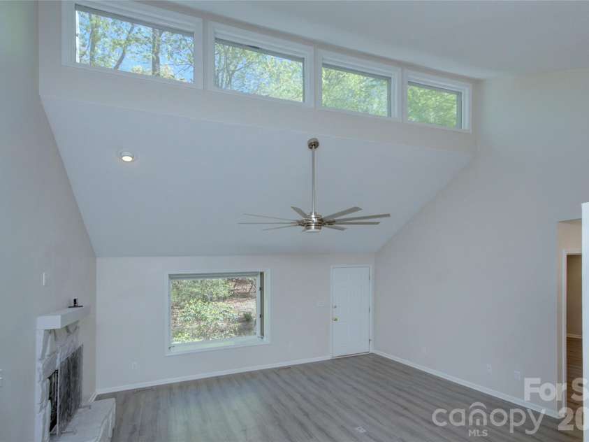 960 Middle Connestee Trail, Brevard, NC 28712.  MLS# CAR4373421, YatesRealty ID 17355. Living room area view from dining room
