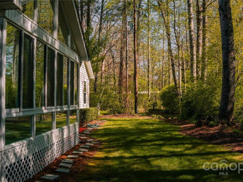 9 Manakiki Court, Etowah, NC 28729.  MLS# CAR4245266, YatesRealty ID 17356. Back Yard/ Four Seasons room