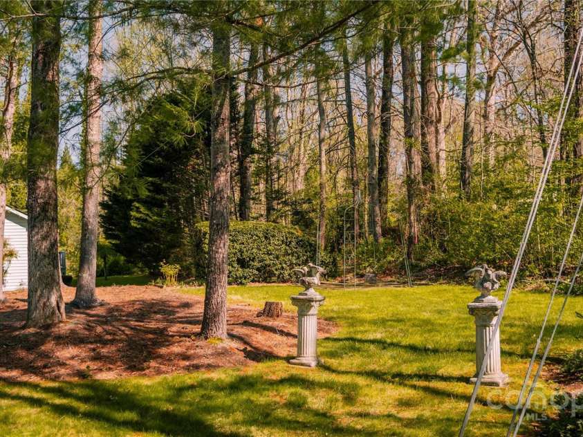 9 Manakiki Court, Etowah, NC 28729.  MLS# CAR4245266, YatesRealty ID 17356. Side yard