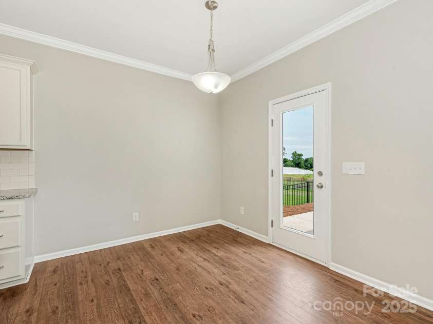 4912 Grace View Drive, Pineville, NC 28134.  MLS# CAR4261040, YatesRealty ID 17367. Breakfast room and door to the patio.