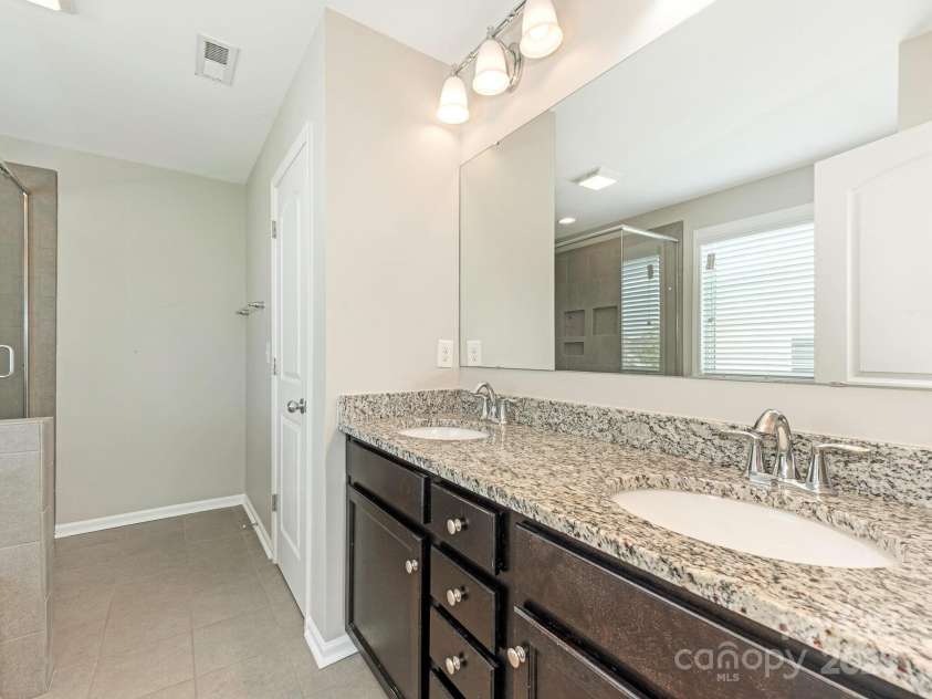 4912 Grace View Drive, Pineville, NC 28134.  MLS# CAR4261040, YatesRealty ID 17367. Double vanity in the primary bedroom.