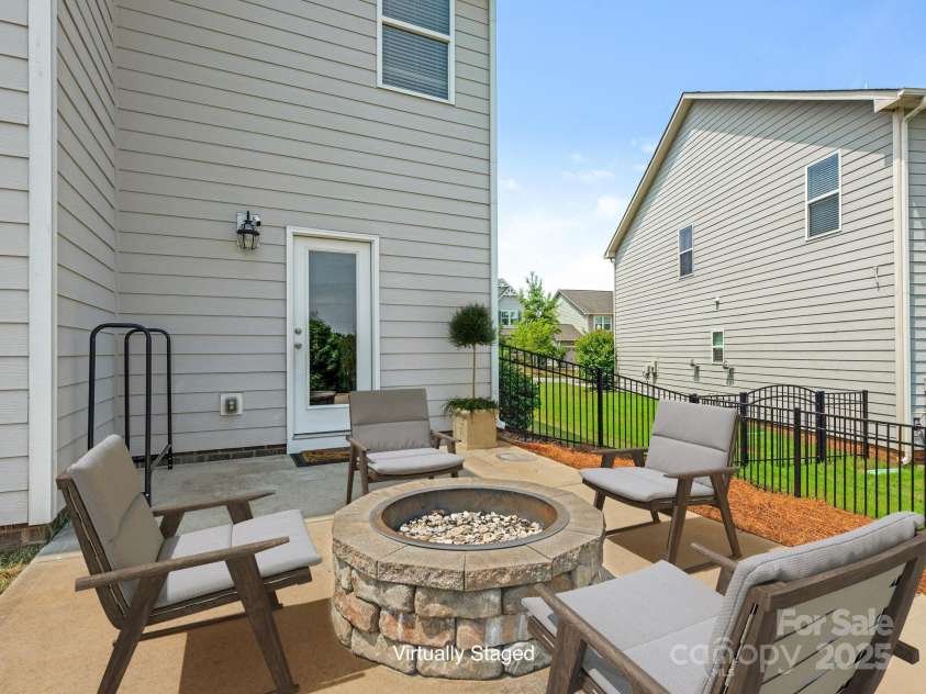 4912 Grace View Drive, Pineville, NC 28134.  MLS# CAR4261040, YatesRealty ID 17367. Virtually Staged Patio with a beautiful stone firepit!