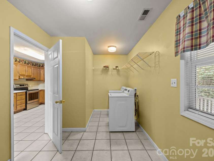 73 Waters Road, Asheville, NC 28805.  MLS# CAR4364687, YatesRealty ID 17378. Large laundry room just off the kitchen