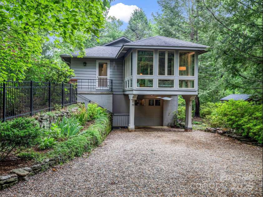 185 Greenstoke Loop, Tryon, NC 28782.  MLS# CAR4261125, YatesRealty ID 17387. Driveway leads to a one car garage and steps leading to the kitchen door and the front entrance