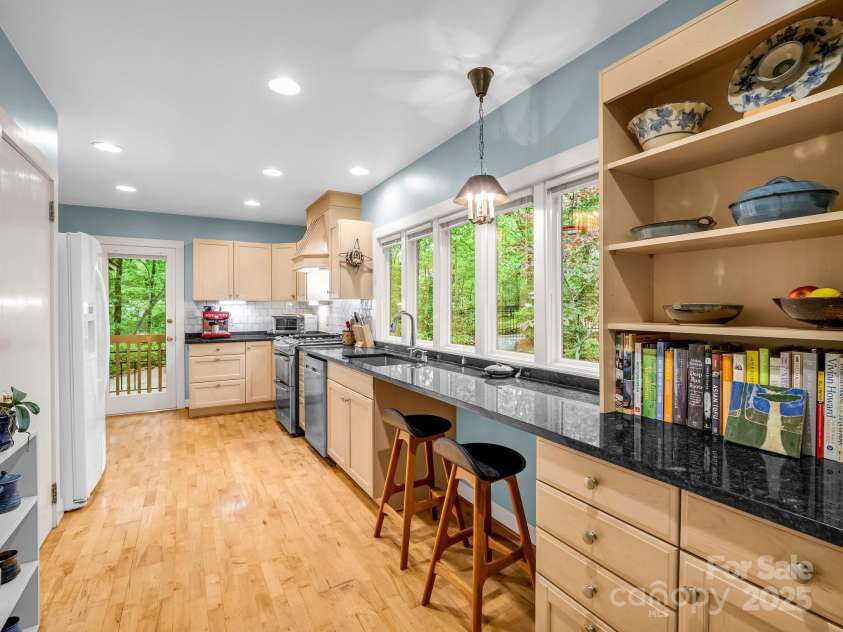 185 Greenstoke Loop, Tryon, NC 28782.  MLS# CAR4261125, YatesRealty ID 17387. Side door leads to the stairs to the garage and driveway