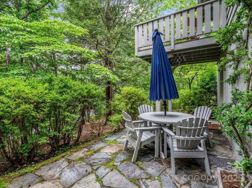 185 Greenstoke Loop, Tryon, NC 28782.  MLS# CAR4261125, YatesRealty ID 17387. Stone patio on the left side of the house