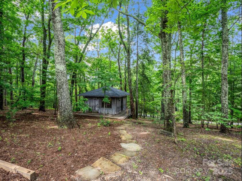 185 Greenstoke Loop, Tryon, NC 28782.  MLS# CAR4261125, YatesRealty ID 17387. Studio tucked in the woods a few steps from the house