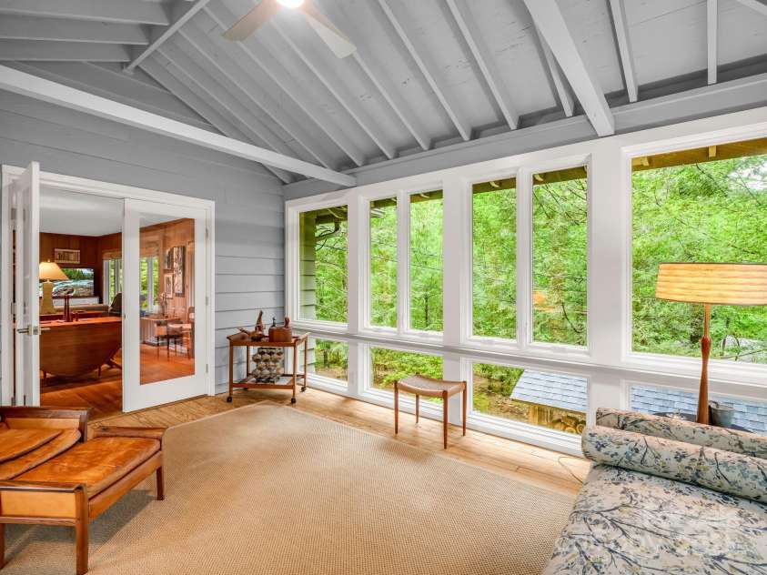 185 Greenstoke Loop, Tryon, NC 28782.  MLS# CAR4261125, YatesRealty ID 17387. Sunroom with ceiling fan is steps away from the Dining area