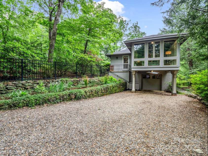 185 Greenstoke Loop, Tryon, NC 28782.  MLS# CAR4261125, YatesRealty ID 17387. Wrought iron fencing around the front of the property