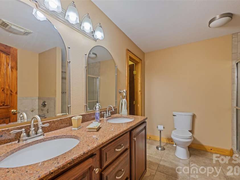 235 Soaring Eagle Road, Bryson City, NC 28713.  MLS# CAR4316418, YatesRealty ID 1739. Primary bathroom suite with walk-in closet 