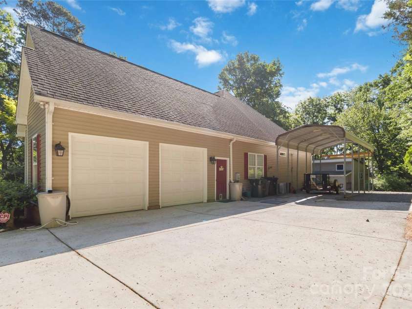 2923 Meadow Creek Lane, Monroe, NC 28110.  MLS# CAR4255594, YatesRealty ID 17394. Oversized parking pad with RV cover and power outlet