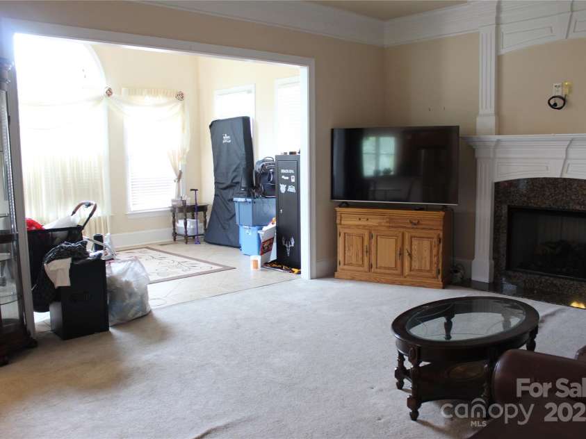 8620 Rolling Fields Road, Charlotte, NC 28227.  MLS# CAR4266446, YatesRealty ID 17398. Greatroom with Gas Logs Fireplace opens to beautiful and bright Sunroom!