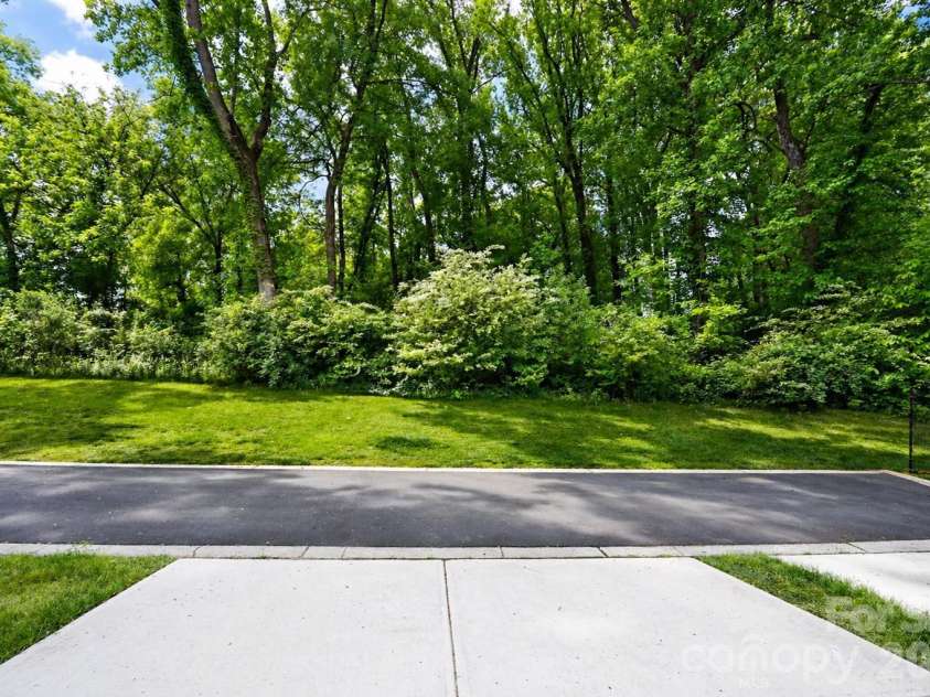 12008 John Newton Drive, Davidson, NC 28036.  MLS# CAR4375341, YatesRealty ID 17400. Back View From Drive to Trees