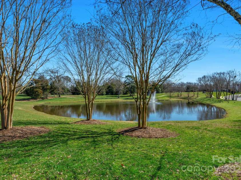 2711 Liberty Hall Court, Waxhaw, NC 28173.  MLS# CAR4228548, YatesRealty ID 17401. Pond located on the corner of Liberty Hall Court has a path and plenty of green space.