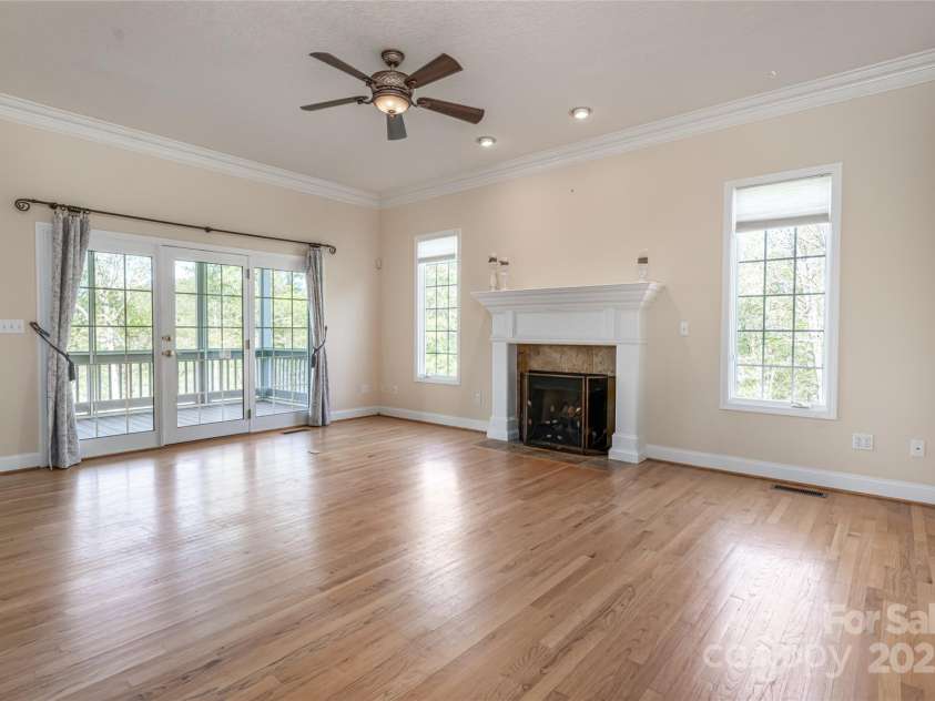 8 Scarlet Rdg Lane, Weaverville, NC 28787.  MLS# CAR4233209, YatesRealty ID 17414. Lovely hardwood floors in Living room with fireplace and access to screened porch