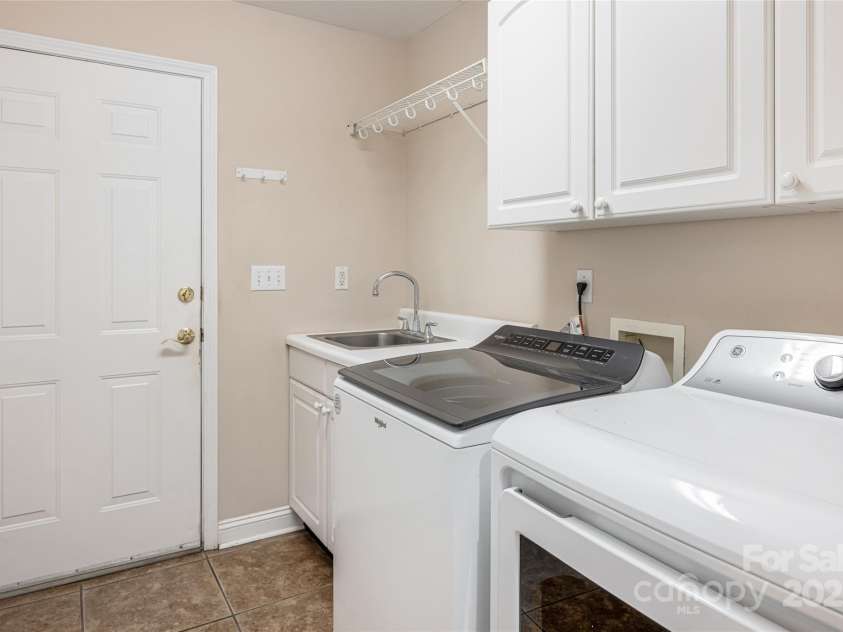 8 Scarlet Rdg Lane, Weaverville, NC 28787.  MLS# CAR4233209, YatesRealty ID 17414. Separate laundry room with utility sink and cabinetry