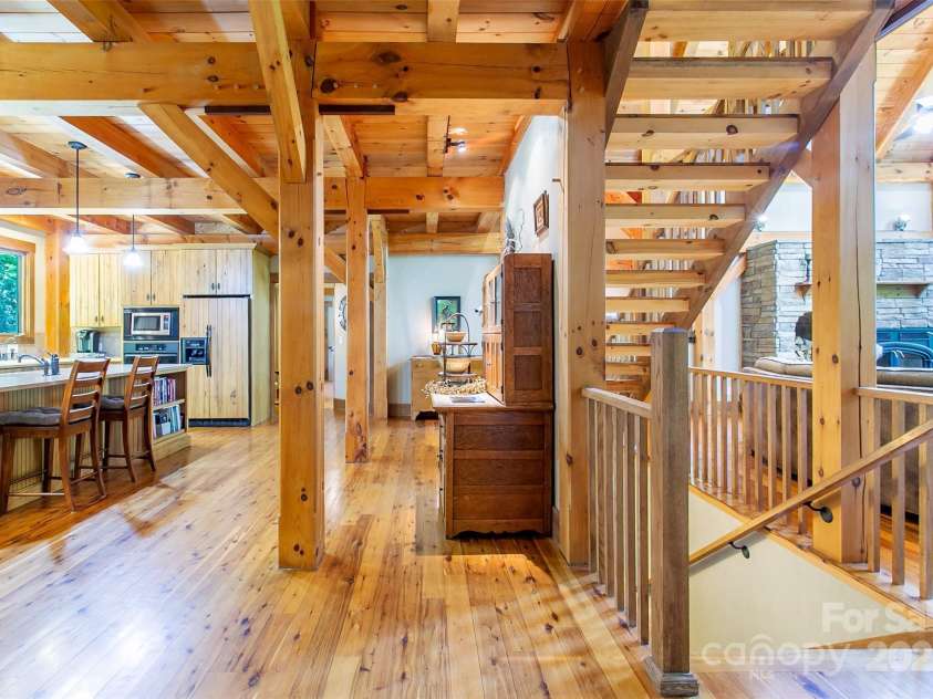 58 Great Aspen Way, Black Mountain, NC 28711.  MLS# CAR4256095, YatesRealty ID 17415. A look at the kitchen island, stairway, and sunny living area.