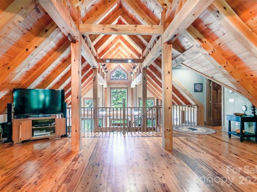 58 Great Aspen Way, Black Mountain, NC 28711.  MLS# CAR4256095, YatesRealty ID 17415. A look at the large living room windows and outdoors from the loft.