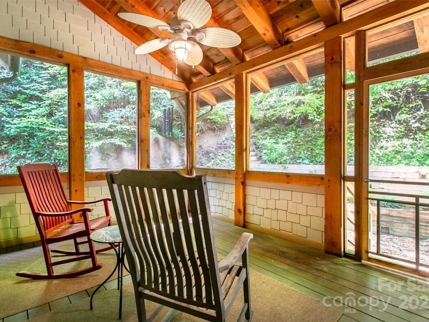 58 Great Aspen Way, Black Mountain, NC 28711.  MLS# CAR4256095, YatesRealty ID 17415. After dinner, relax and enjoy nature, including fireflies during the summer, from this lovely screened room. 