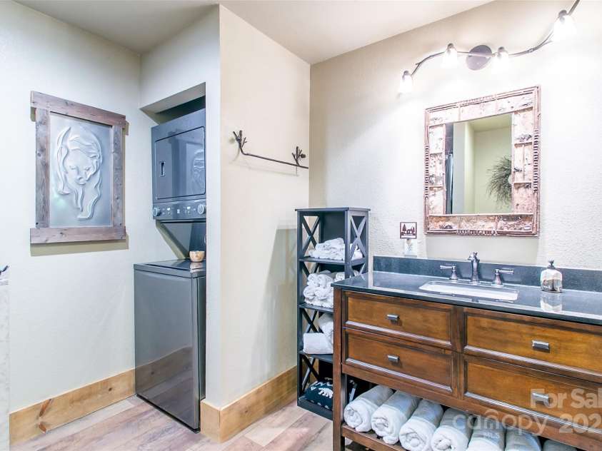 58 Great Aspen Way, Black Mountain, NC 28711.  MLS# CAR4256095, YatesRealty ID 17415. Another look at the downstairs apartment bathroom. Note the stacked washer and dryer and room for towels.