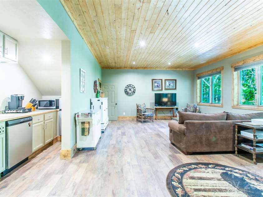 58 Great Aspen Way, Black Mountain, NC 28711.  MLS# CAR4256095, YatesRealty ID 17415. Another look at the downstairs apartment. Note the large windows to bring the outdoors indoors.