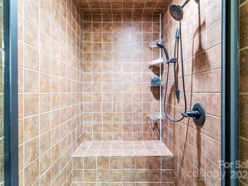 58 Great Aspen Way, Black Mountain, NC 28711.  MLS# CAR4256095, YatesRealty ID 17415. Note how clean and fresh the large primary shower looks. There's another one just like it upstairs in the loft bedroom's bathroom.