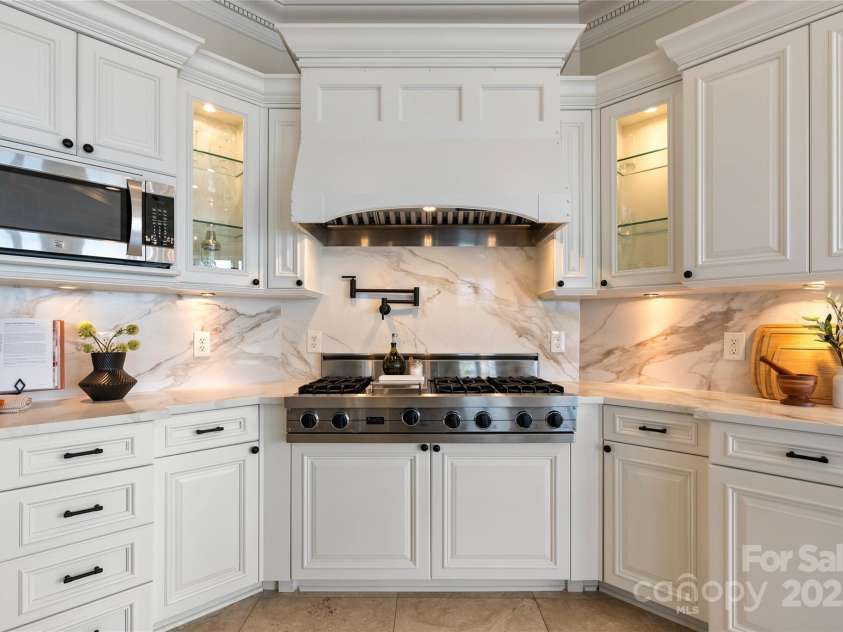 325 Ivy Arbor Circle, Rock Hill, SC 29732.  MLS# CAR4242278, YatesRealty ID 17417. Floor 1- custom hood vent with pot filler and gas cooktop