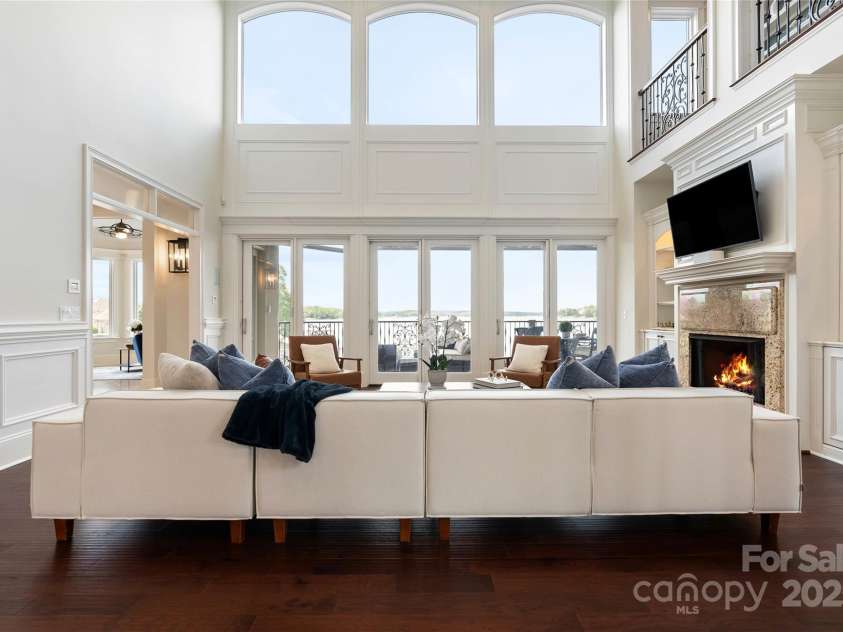 325 Ivy Arbor Circle, Rock Hill, SC 29732.  MLS# CAR4242278, YatesRealty ID 17417. Floor 1- Living Room with floor to ceiling windows, lake views and coffered ceilings