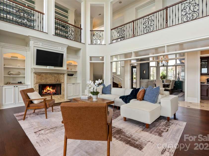 325 Ivy Arbor Circle, Rock Hill, SC 29732.  MLS# CAR4242278, YatesRealty ID 17417. Floor 1-Living Room with floor to ceiling windows, lake views and coffered ceilings