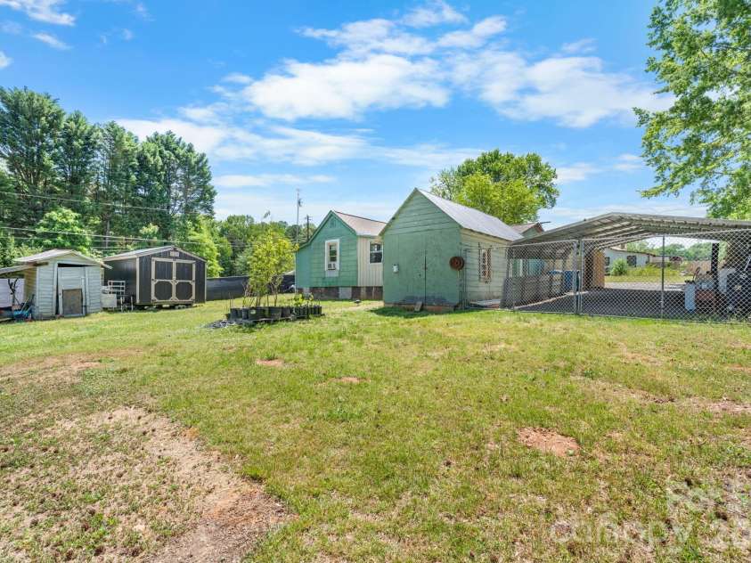 3706 2nd Avenue, Hickory, NC 28601.  MLS# CAR4374944, YatesRealty ID 17428. Back yard facing home and carport