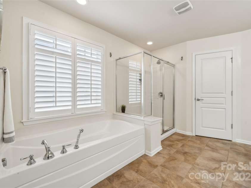 5046 Cressingham Drive, Fort Mill, SC 29707.  MLS# CAR4263729, YatesRealty ID 17429. Soaking tub and walk in shower