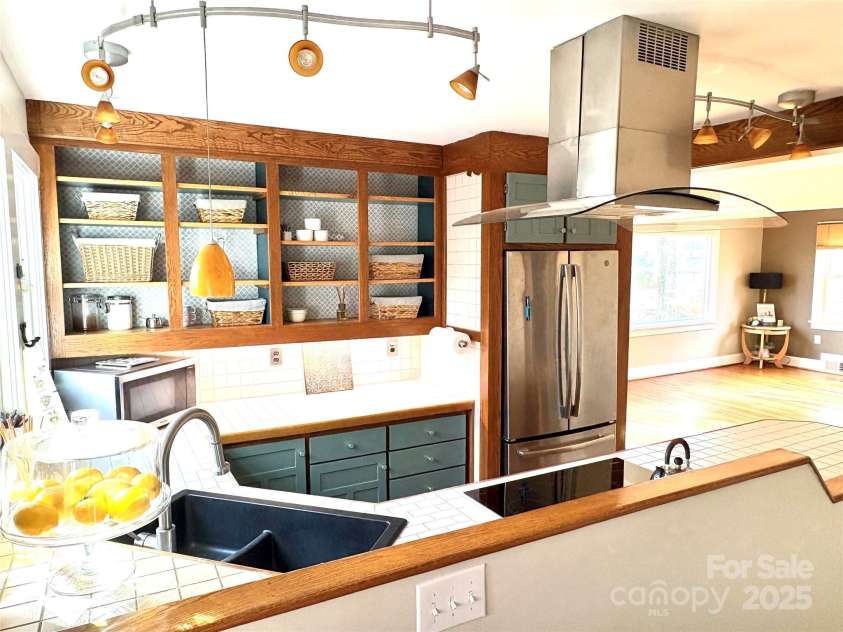 114 Broadway Avenue, Tryon, NC 28782.  MLS# CAR4322856, YatesRealty ID 17430. Kitchen opens up to the dining area and living room. 