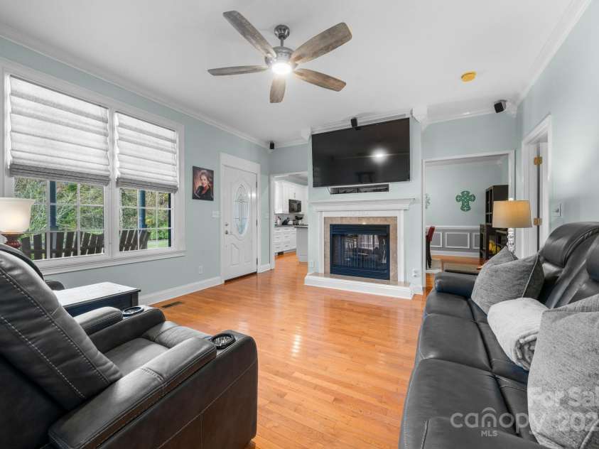 1246 Hillsboro Avenue, Hickory, NC 28602.  MLS# CAR4199854, YatesRealty ID 1745. Beautiful windows overlooking the Rock N Chair front porch.  Mounted TV and see though fireplace to Kitchen/  dining area.